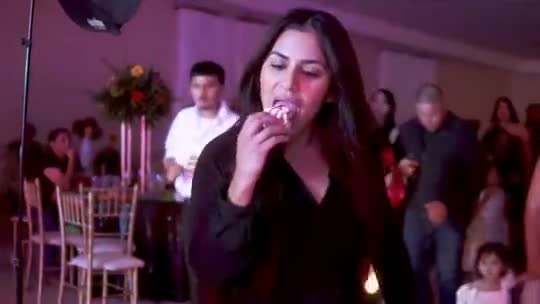 A woman in a black outfit making her entrance at a party